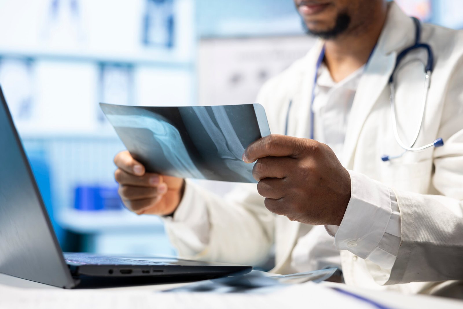 african american doctor analyzing radiography test results for recovery plan